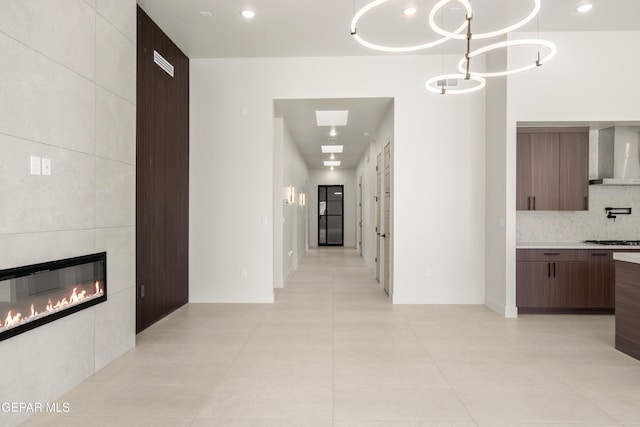 hallway with light tile patterned floors, baseboards, and recessed lighting