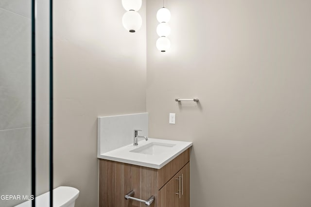 bathroom featuring toilet and vanity