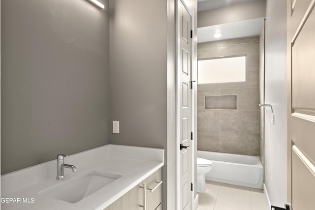 bathroom featuring tile patterned floors, toilet, vanity, and bathtub / shower combination