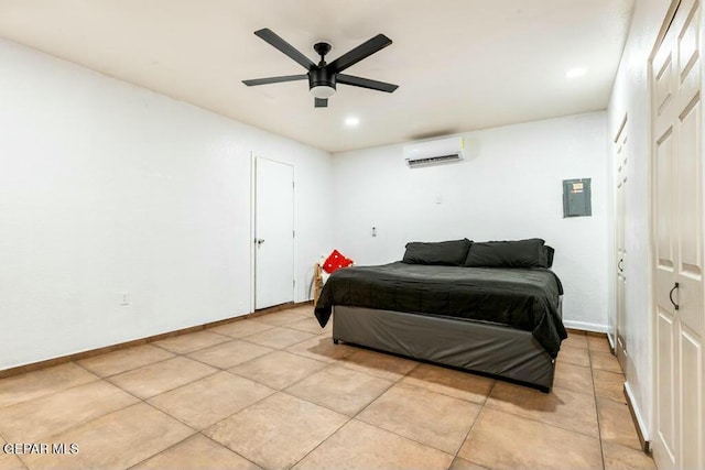 bedroom with ceiling fan, baseboards, an AC wall unit, and light tile patterned flooring