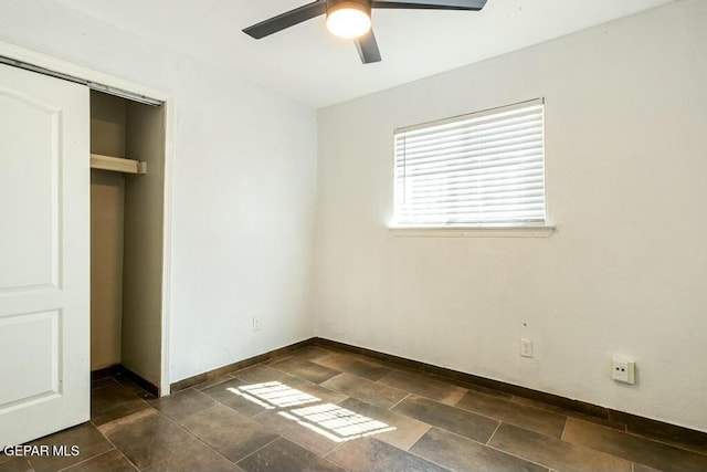 unfurnished bedroom featuring baseboards and ceiling fan