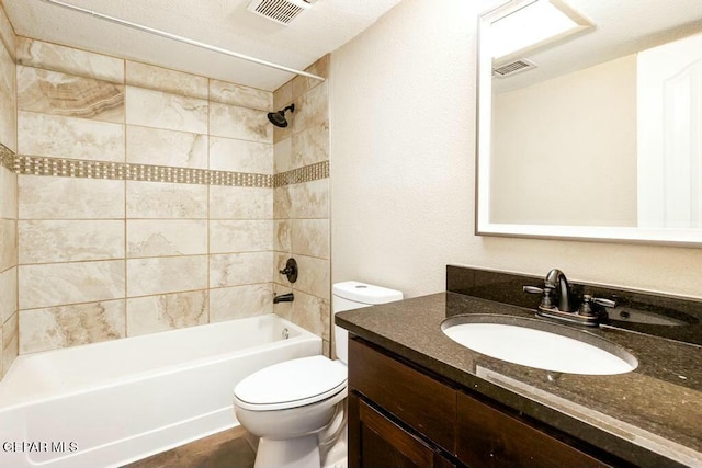 full bath with visible vents, tub / shower combination, toilet, and vanity