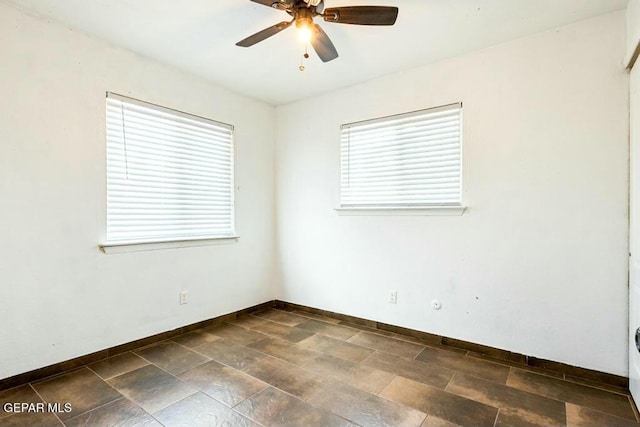 empty room with baseboards and ceiling fan