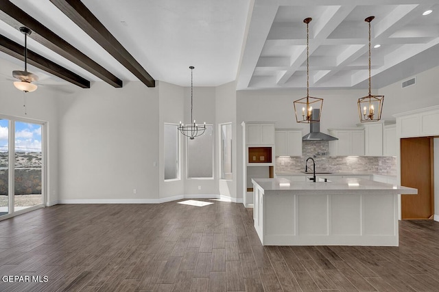 kitchen with tasteful backsplash, visible vents, light countertops, and dark wood-style flooring