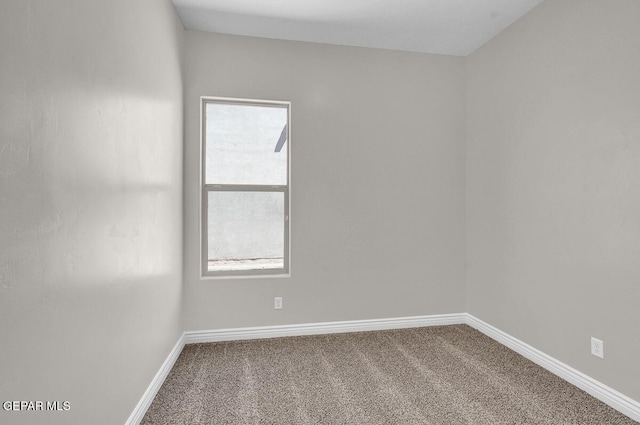 unfurnished room featuring baseboards and carpet floors