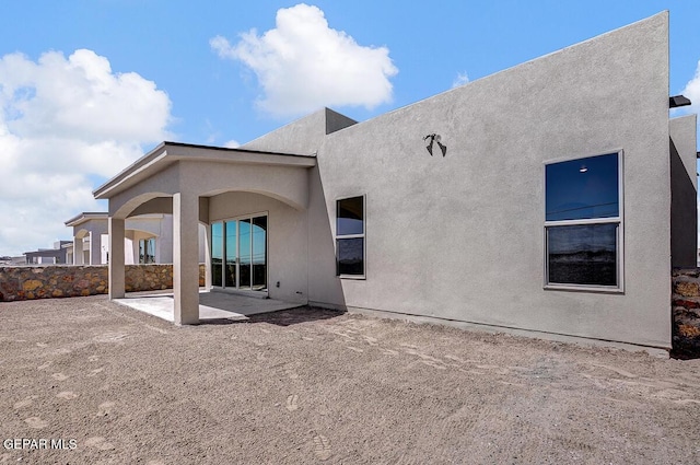 back of house featuring a patio and stucco siding