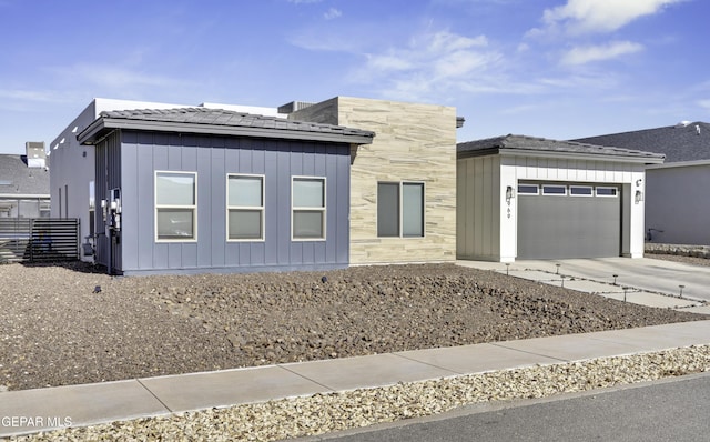 view of front facade featuring a garage, board and batten siding, and concrete driveway