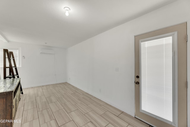 unfurnished room with a wall mounted AC