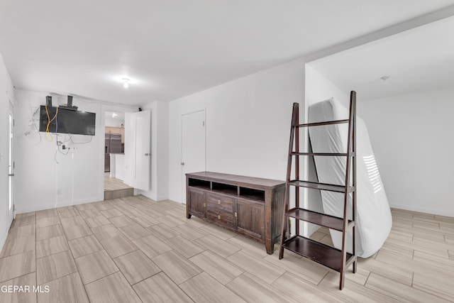 interior space featuring wood finish floors and baseboards