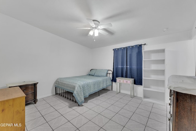 bedroom featuring light tile patterned floors, baseboards, and a ceiling fan