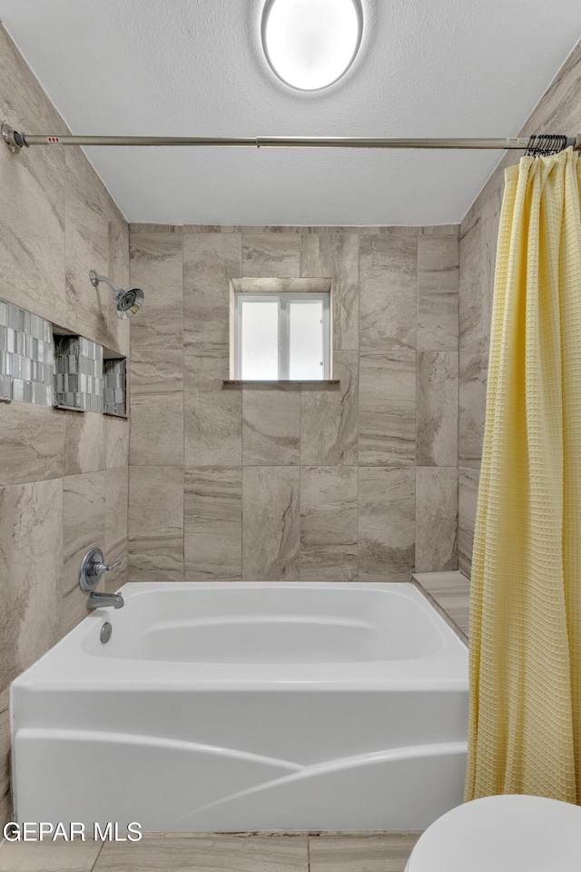 full bath featuring toilet and shower / bathtub combination with curtain