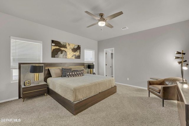 bedroom with carpet flooring, visible vents, baseboards, and ceiling fan