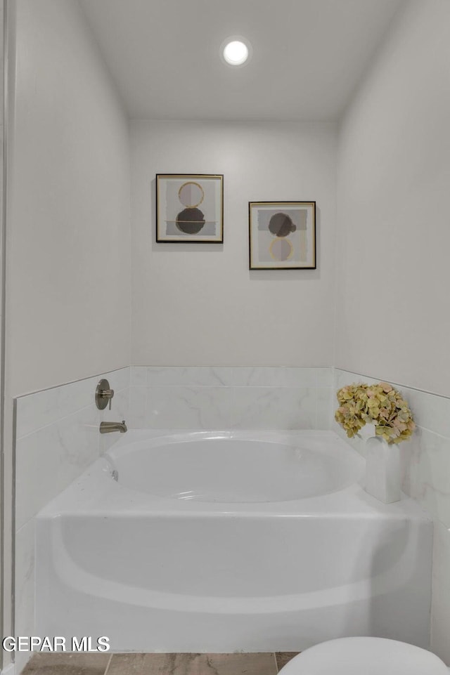 full bathroom with recessed lighting, toilet, and a garden tub