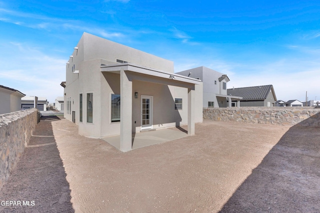 back of property featuring a patio area, fence, and stucco siding