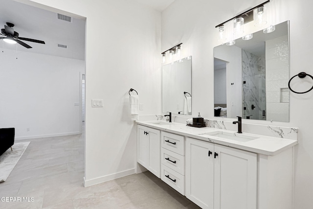 bathroom with ceiling fan, a stall shower, visible vents, and a sink