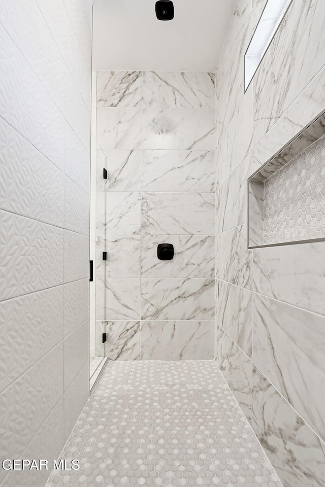 bathroom with tiled shower