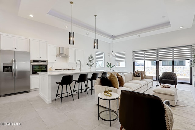 living room featuring recessed lighting, a raised ceiling, a towering ceiling, and light tile patterned floors