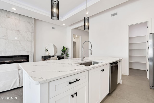 kitchen featuring light stone counters, visible vents, white cabinets, appliances with stainless steel finishes, and open floor plan