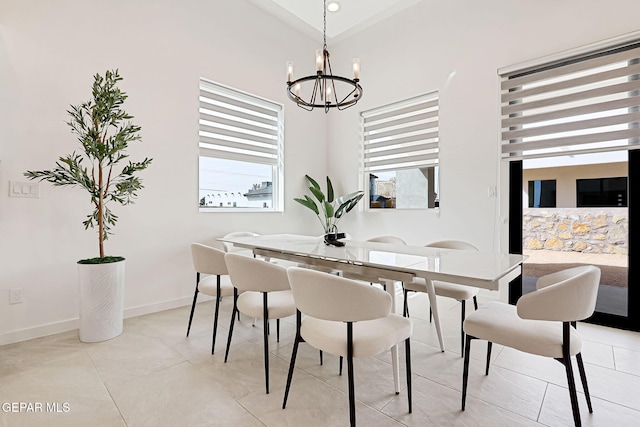 dining area with a notable chandelier, baseboards, and a wealth of natural light