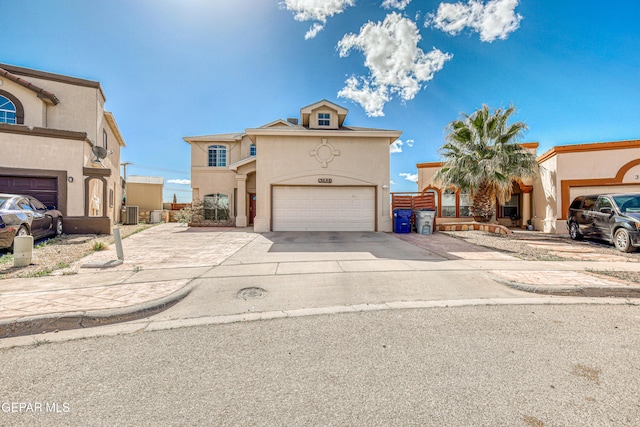 view of front facade featuring cooling unit, stucco siding, driveway, and an attached garage