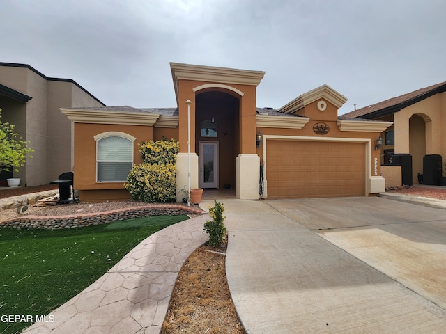 mediterranean / spanish-style home featuring an attached garage, driveway, and stucco siding