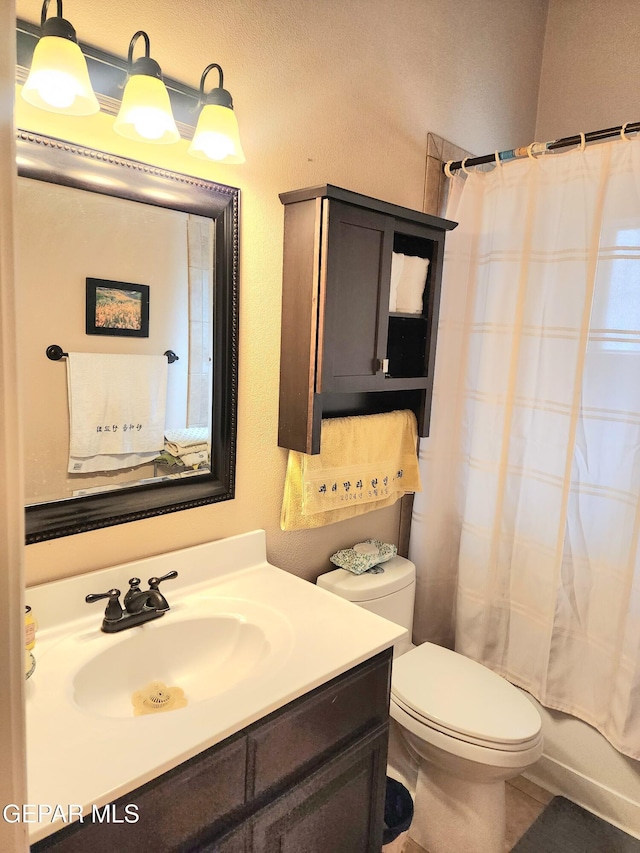 bathroom with toilet, shower / bath combo, and vanity