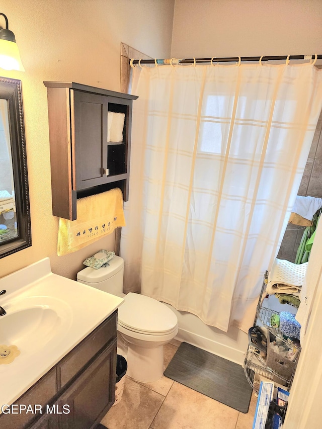 full bathroom with shower / tub combo, toilet, vanity, and tile patterned flooring