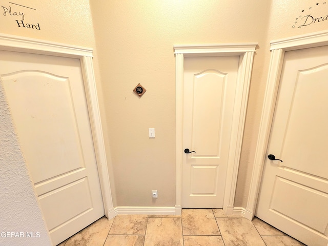 hallway featuring baseboards