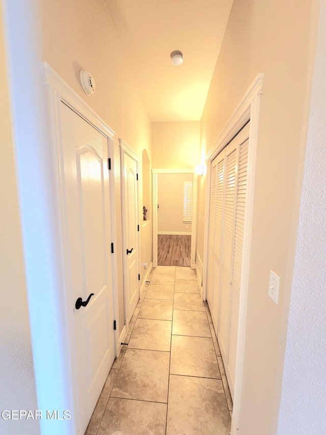 hall with light tile patterned floors