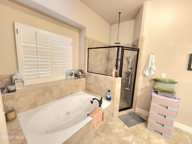 bathroom with tile patterned flooring, a tub with jets, and a shower stall