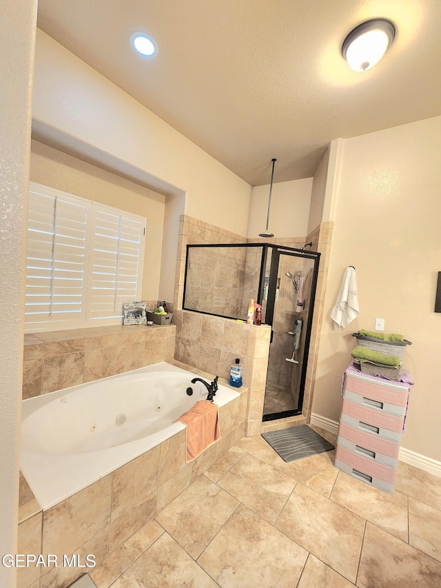 full bathroom featuring tile patterned flooring, a shower stall, and a whirlpool tub