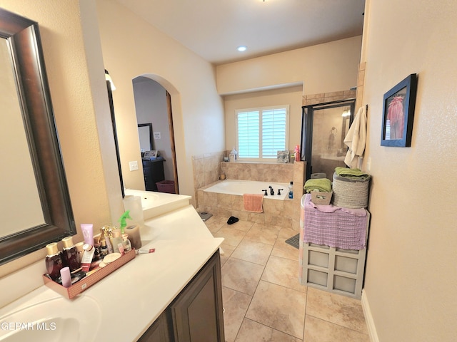 full bathroom featuring tile patterned flooring, a shower stall, vanity, and a garden tub