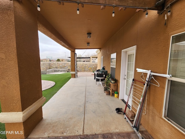 view of patio / terrace featuring fence