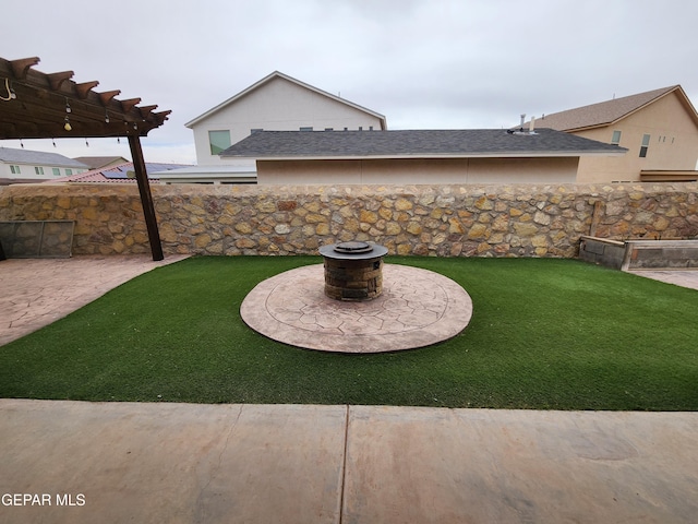 view of yard with fence, an outdoor fire pit, and a patio area