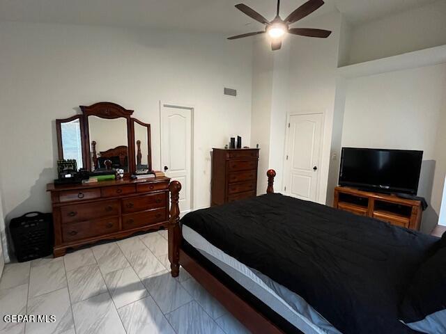 bedroom featuring visible vents, high vaulted ceiling, marble finish floor, and ceiling fan