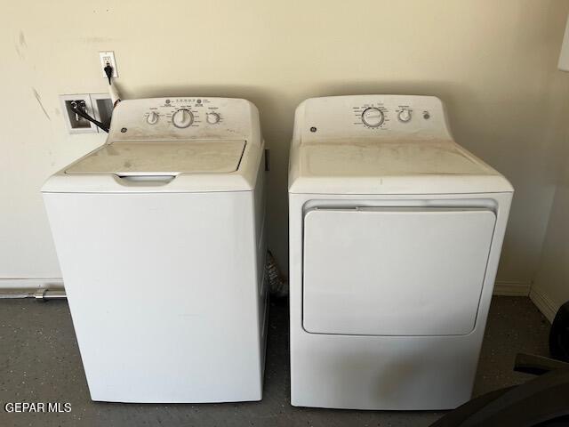 washroom featuring laundry area and washing machine and dryer