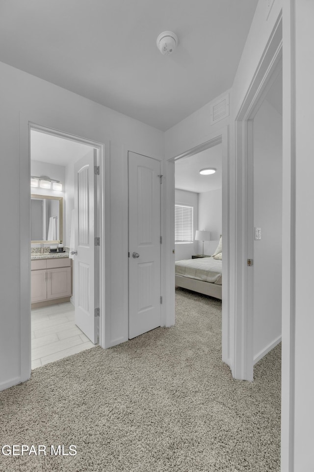 interior space featuring visible vents, carpet flooring, and ensuite bathroom