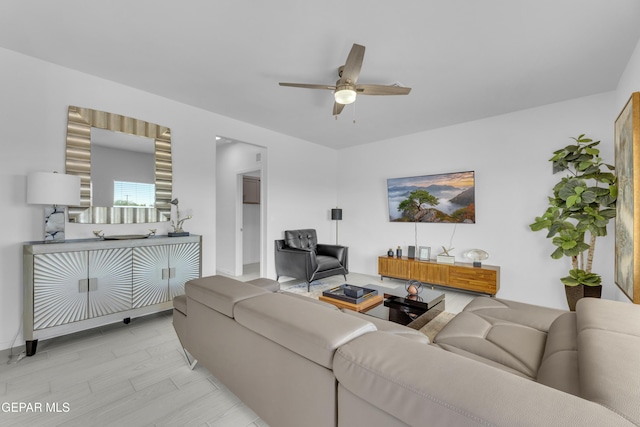 living area with light wood-type flooring and ceiling fan