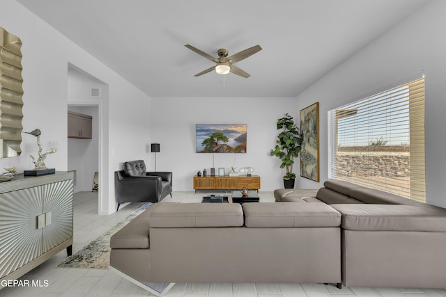 living area featuring visible vents and a ceiling fan