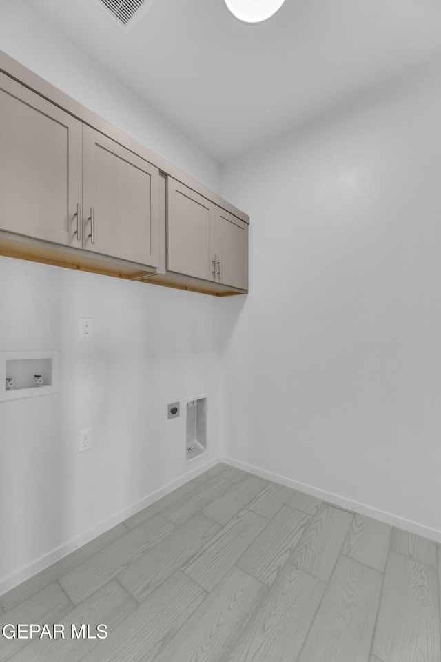 laundry area featuring visible vents, baseboards, washer hookup, cabinet space, and hookup for an electric dryer