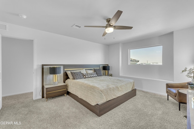 bedroom featuring baseboards, carpet floors, visible vents, and ceiling fan