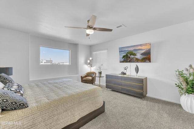 bedroom featuring visible vents, carpet floors, baseboards, and ceiling fan