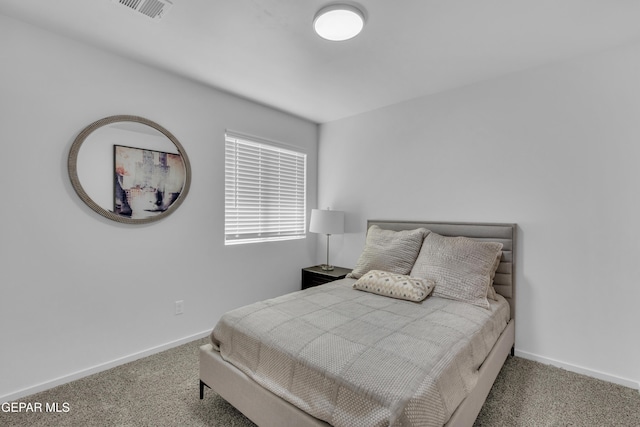 carpeted bedroom with visible vents and baseboards