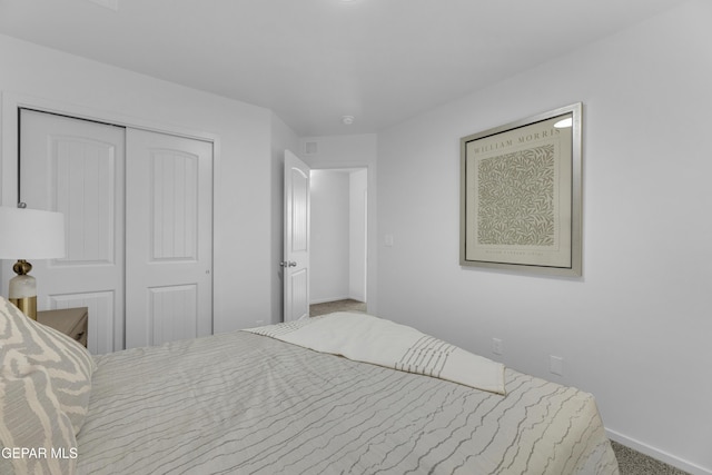 bedroom with a closet, baseboards, and carpet floors