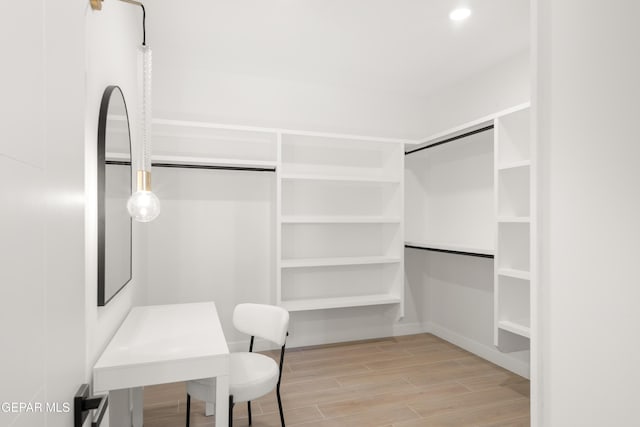 walk in closet with wood tiled floor