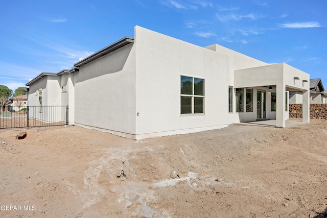 back of property featuring a patio area, fence, and stucco siding