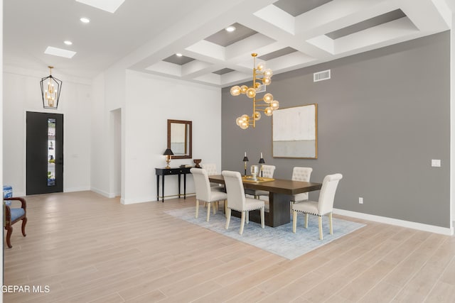 dining area featuring light wood finished floors, visible vents, baseboards, a notable chandelier, and coffered ceiling