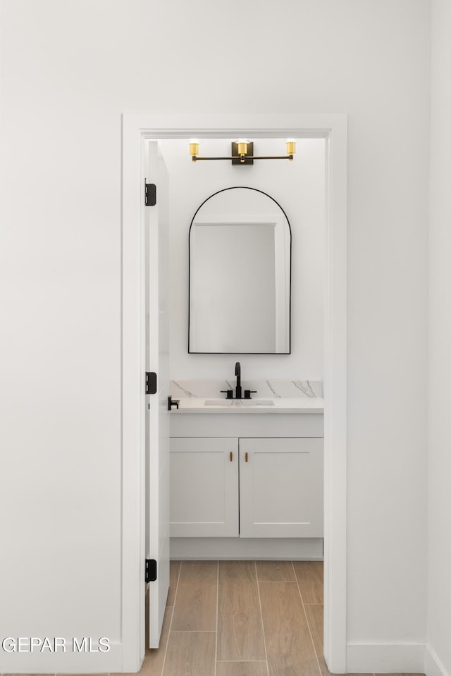 bathroom with wood finish floors and vanity