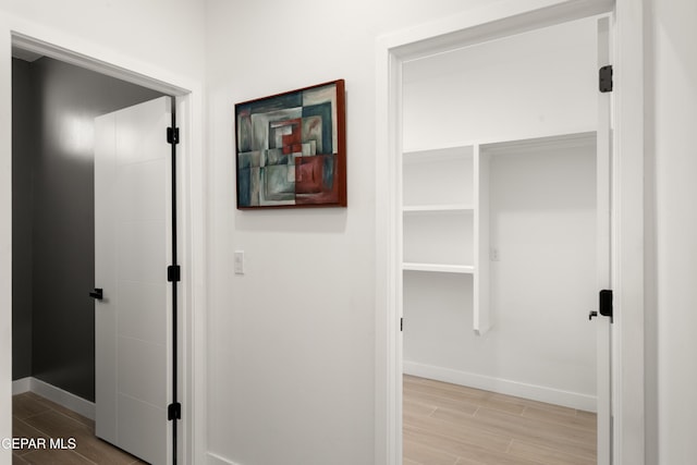 hall with wood finish floors and baseboards