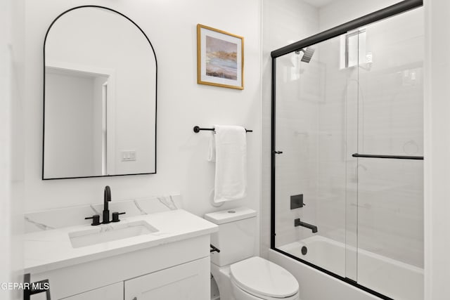 full bathroom featuring vanity, toilet, and combined bath / shower with glass door